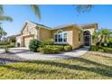 A charming, single story home showcasing well-kept landscaping and a welcoming walkway to the front door at 2253 Oakley Green Dr # 26, Sun City Center, FL 33573