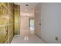 Entryway view with tile flooring leading to a large living space, with an ornate art piece on the wall at 2457 Orangepointe Ave, Palm Harbor, FL 34683