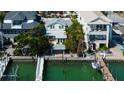 Waterfront property with boat dock, lush greenery, and ample space for outdoor entertainment at 2605 Pass A Grille Way, St Pete Beach, FL 33706