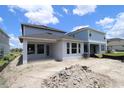 Exterior view of the home showcasing the backyard with large windows at 28740 Jujube Rd, Wesley Chapel, FL 33543