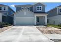Charming two-story home featuring a two-car garage and neatly paved driveway at 28740 Jujube Rd, Wesley Chapel, FL 33543