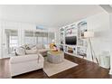 Bright living room with a comfortable couch, a built-in shelving unit, and elegant decor at 292 42Nd Ave, St Pete Beach, FL 33706