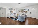 Inviting living room featuring hardwood floors, a cozy sofa, and natural light, perfect for relaxation at 292 42Nd Ave, St Pete Beach, FL 33706