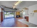 Spacious garage with ample shelving and storage, featuring an open door and view of the neighborhood at 3210 Mcmath Dr, Palm Harbor, FL 34684