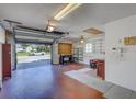 Spacious garage with ample shelving and storage, featuring an open door and view of the neighborhood at 3210 Mcmath Dr, Palm Harbor, FL 34684