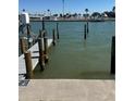 Private dock extends into the tranquil water, providing easy access for boating at 337 Rex Pl # B, Madeira Beach, FL 33708