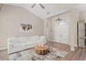 Bright living room showcasing high ceilings, hardwood floors, and a cozy seating arrangement at 5141 Sunnydale W Cir, Sarasota, FL 34233