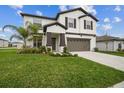 Charming two-story home with well-manicured lawn and a two-car garage, offering curb appeal and convenience at 6241 Spider Lily Way, New Port Richey, FL 34653