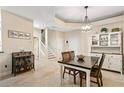 Open concept dining area featuring tile floors, stairs to the second floor, and modern light fixture at 6345 Vista Verde E Dr, Gulfport, FL 33707