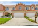 Inviting two-story townhome with a spacious driveway and well-maintained lawn and colorful terra cotta tiled roof at 6345 Vista Verde E Dr, Gulfport, FL 33707