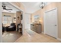 Inviting foyer with decorative console table and view into the spacious living area at 7069 Key Haven Rd # 205, Seminole, FL 33777