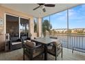 Relaxing screened lanai with comfortable seating and serene waterfront views at 7069 Key Haven Rd # 205, Seminole, FL 33777