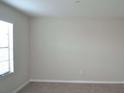 Clean and bright bedroom with neutral paint and window at 10111 Rosemary Leaf Ln, Riverview, FL 33578