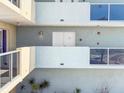 A close exterior view of the condo with multiple windows and balcony at 1100 Pinellas Bayway S # H2, Tierra Verde, FL 33715
