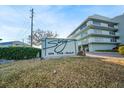 Exterior shot of the 'Sterling on the Gulf' building with well-maintained landscaping at 1100 Pinellas Bayway S # H2, Tierra Verde, FL 33715
