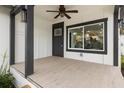 The spacious front porch features a ceiling fan and tile flooring, perfect for enjoying the outdoors at 1103 E Louisiana Ave, Tampa, FL 33603