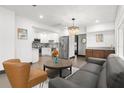 Open-concept living area showcasing a modern kitchen, elegant lighting, and stylish furnishings at 1103 E Louisiana Ave, Tampa, FL 33603