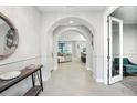 Bright foyer with arched doorways leading to the living areas, and a decorative console table at 13176 Twin Bridges Dr, Riverview, FL 33579