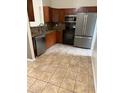 Well-equipped kitchen with stainless steel appliances, wooden cabinets, and granite countertops at 1525 Kestrel Way, Brandon, FL 33511