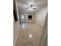 Spacious living room with tile flooring, ceiling fan, and large windows offering abundant natural light at 1525 Kestrel Way, Brandon, FL 33511