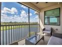 Inviting balcony with seating and a glass table overlooking lake and golf course views at 17724 Gawthrop Dr # 402, Bradenton, FL 34211