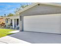 Two car garage with a newly paved driveway on a charming gray brick home at 1842 Oklahoma Ne Ave, St Petersburg, FL 33703