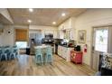 Open kitchen with stainless appliances, light wood floors, and eat in dining area at 2504 Avenue B # A, Bradenton Beach, FL 34217