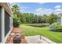 Serene backyard view with lush greenery and a tranquil pond, creating a private and relaxing outdoor space at 29312 Marker Loop, San Antonio, FL 33576