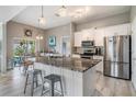 Modern kitchen featuring stainless steel appliances, granite countertops, and a stylish breakfast bar with seating at 29312 Marker Loop, San Antonio, FL 33576