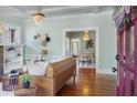 Open-concept living area showcasing hardwood floors, a decorative fireplace, and seamless flow to dining space at 3000 4Th N Ave, St Petersburg, FL 33713