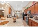 Spacious kitchen with granite countertops, stainless steel appliances, and ample cabinet space at 313 Old Windsor Way, Spring Hill, FL 34609