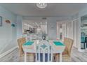 Dining room with an oval table, wicker chairs, and views to the kitchen at 4650 Bay Blvd # 1012, Port Richey, FL 34668