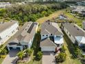 Aerial view showcases the home's roof, solar panels, well-manicured yard, and surrounding neighborhood at 5232 Wishing Arch Dr, Apollo Beach, FL 33572