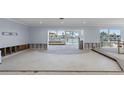 Bright living room with water views and sliding glass doors, needing renovation at 5451 Oakhurst Dr, Seminole, FL 33772