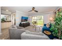 Comfortable living room with gray armchairs, blue sofa, and sliding doors to the outside at 5900 Bahia Del Mar Cir # 137, St Petersburg, FL 33715