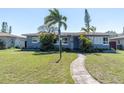 Charming single-story home with a well-manicured lawn and tropical landscaping, creating a welcoming curb appeal at 6618 3Rd N Ave, St Petersburg, FL 33710