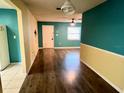 Open-concept living space with wood floors and a bright, airy feel at 7406 Coventry Dr, Port Richey, FL 34668