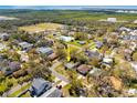 An aerial view of a charming property with a green roof, surrounded by mature trees in a residential neighborhood at 7415 S Obrien St, Tampa, FL 33616