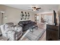 Inviting living room features wood-look flooring, a ceiling fan and an open layout at 9649 Tocobaga Pl, Riverview, FL 33578