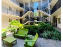 Inviting courtyard with green furniture and lush landscaping, perfect for relaxation at 125 5Th Ne Ave # 240, St Petersburg, FL 33701
