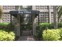 Close-up of the Bay Villas entrance with decorative breeze block walls and lush tropical landscaping at 125 5Th Ne Ave # 240, St Petersburg, FL 33701