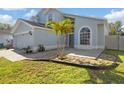Attractive two-story home with well-kept lawn and front yard landscaping, including decorative stone features at 13411 Beechberry Dr, Riverview, FL 33579