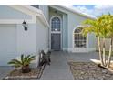 Inviting front entrance with a well-lit pathway and decorative plants, showcasing the home's curb appeal at 13411 Beechberry Dr, Riverview, FL 33579