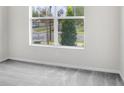 Bedroom with plush neutral carpet and a sunny window overlooking the neighborhood at 2472 Orange Harvest Pl, Seffner, FL 33584