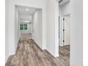 Hallway features neutral walls, white trim and attractive wood flooring at 2472 Orange Harvest Pl, Seffner, FL 33584