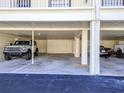 Covered parking area showcasing multiple vehicles, providing sheltered spots for residents and guests at 340 Causeway Blvd # 108, Dunedin, FL 34698
