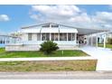 Inviting single-story home with well-maintained lawn and covered carport at 3921 Chris Dr, Wesley Chapel, FL 33543