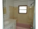 Well-lit bathroom with a vanity, window, and a shower-tub combination at 4851 W Gandy Blvd # B5L19, Tampa, FL 33611