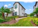 Modern two-story townhouse showcasing a two-car garage and beautifully landscaped yard at 4896 San Martino Dr, Wesley Chapel, FL 33543