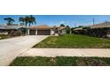 Well manicured lawn with sidewalks leading to the front door and a two car garage at 5342 Sagamore Ct, New Port Richey, FL 34655